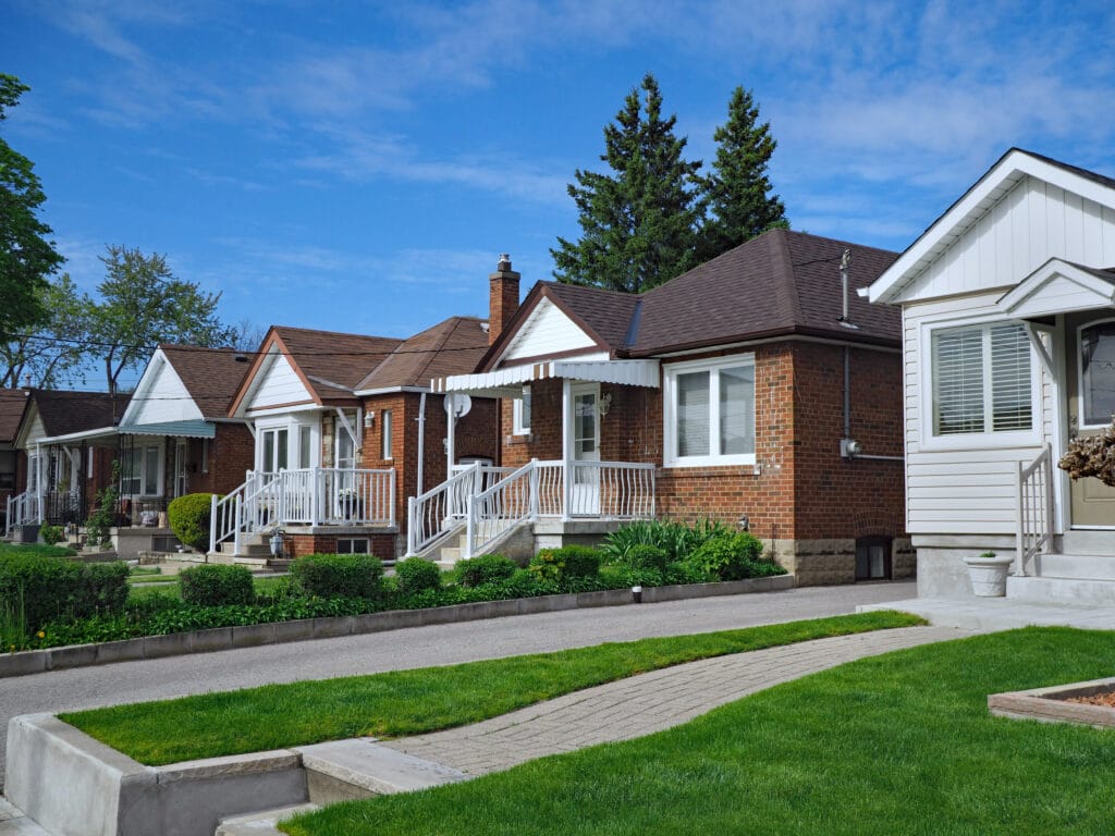 one-story houses with green grass and shrubs